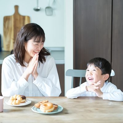 Mother and son pose to start eating in the room