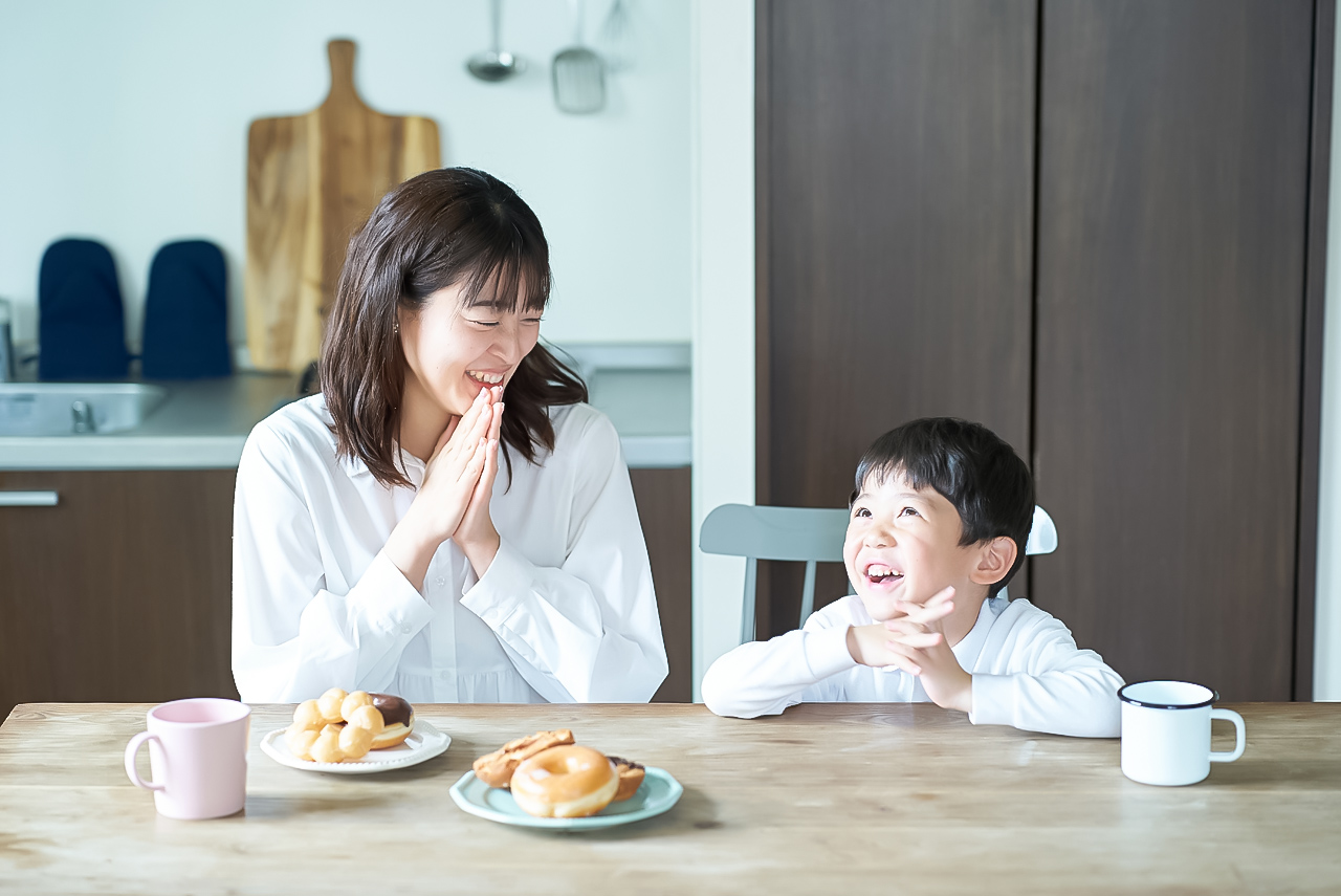 Mother and son pose to start eating in the room